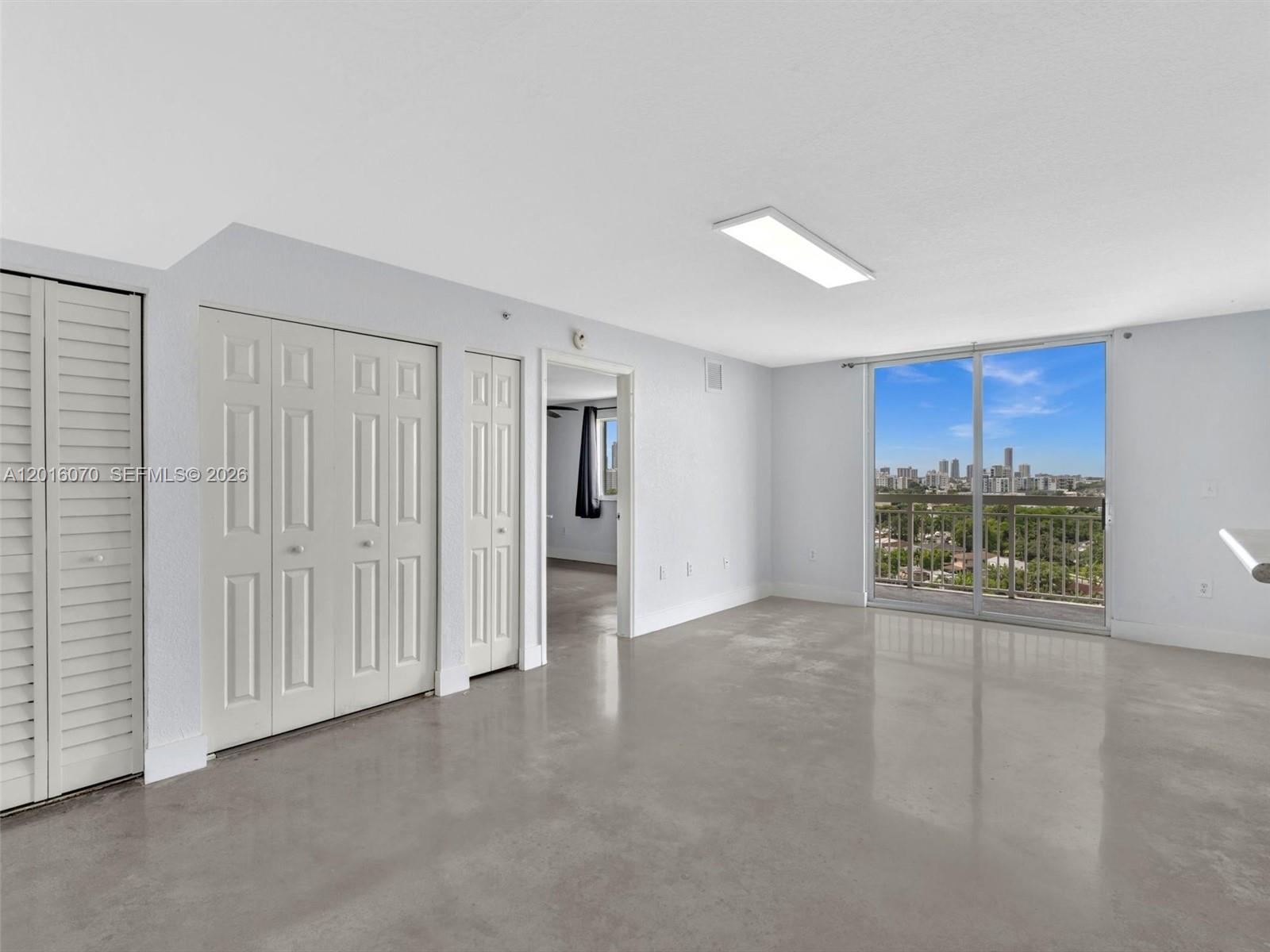 816 Northwest 11th Street, Unit 1208 Miami, FL 33136 - Photo 6 of 49 an empty room with a empty space and window