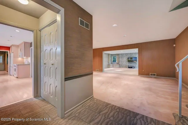 a view of empty room with chandelier and front door