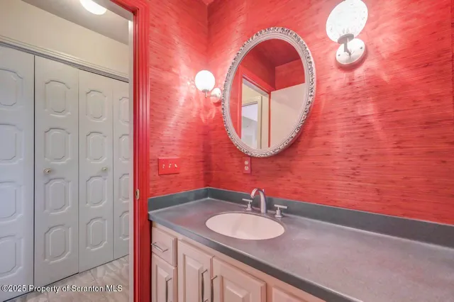 a view of a hallway with wooden floor and windows