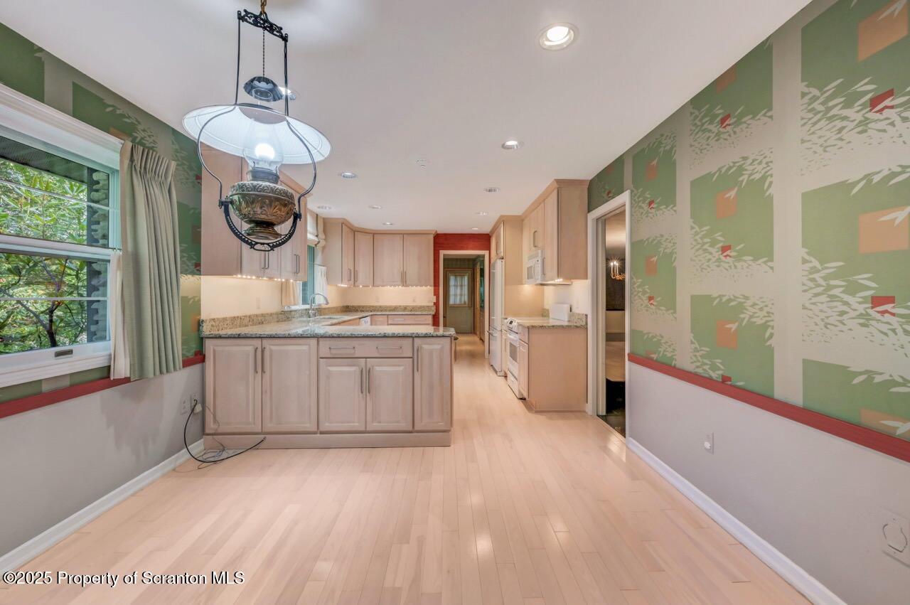 517 Grandview Street Clarks Summit, PA 18411 - Photo 22 of 86 a large kitchen with stainless steel appliances kitchen island granite countertop a refrigerator a stove a microwave and a dining table