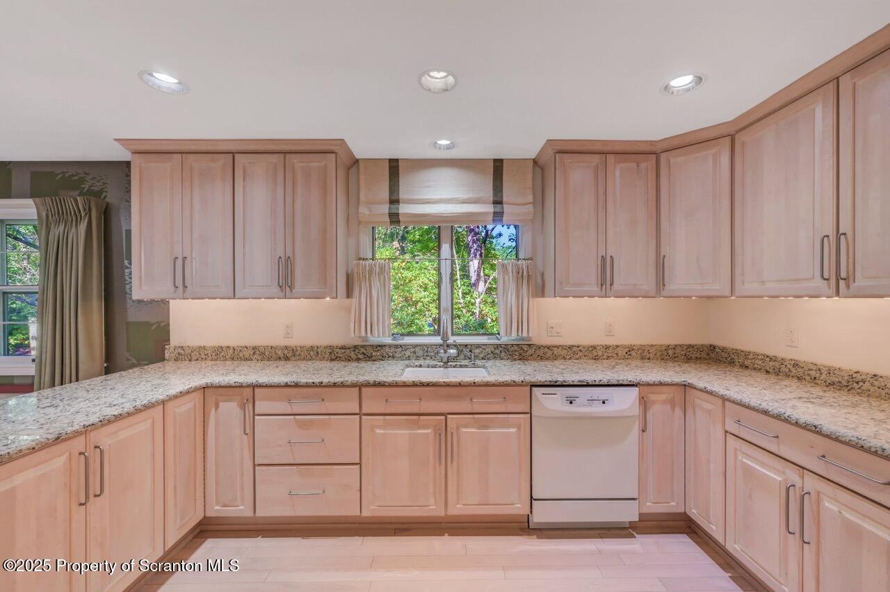 517 Grandview Street Clarks Summit, PA 18411 - Photo 28 of 86 a kitchen with granite countertop wooden cabinets a sink and dishwasher