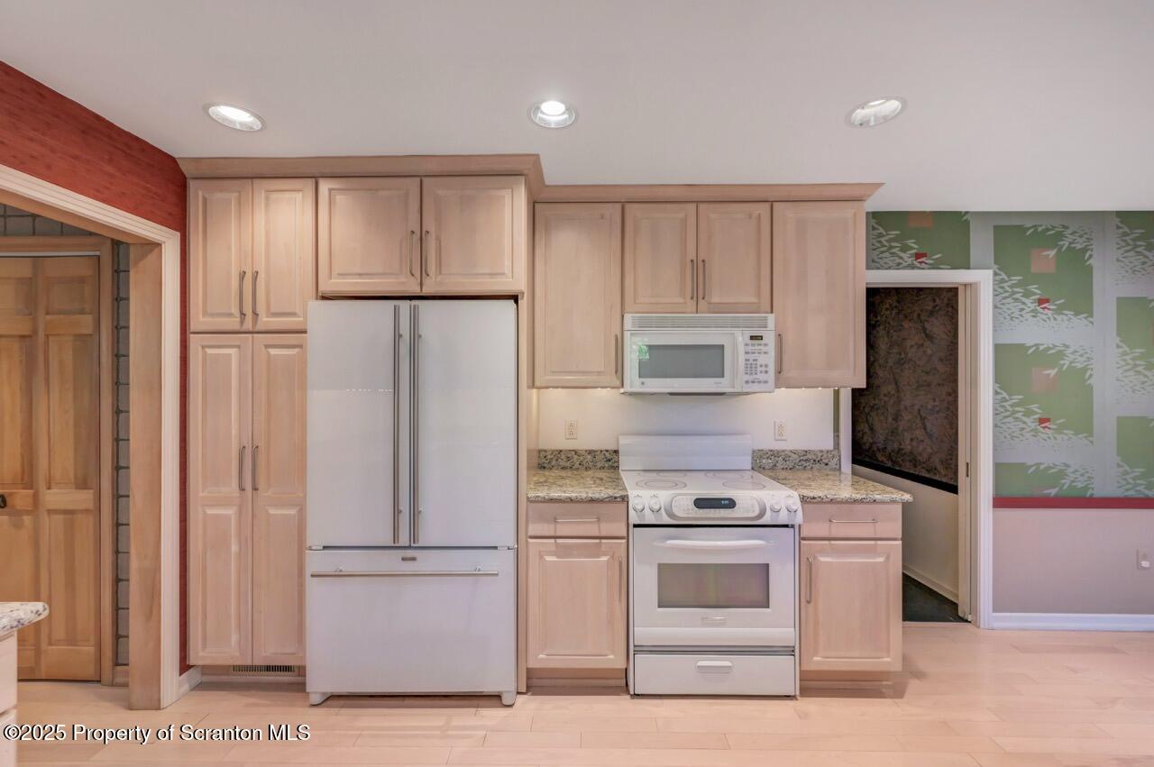 517 Grandview Street Clarks Summit, PA 18411 - Photo 29 of 86 a kitchen with a refrigerator stove and white cabinets