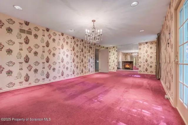 a view of a room with a projector and a rug