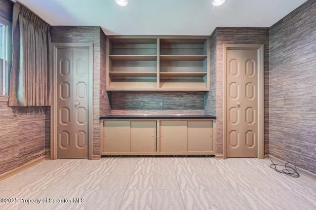 a view of a yard with plants and large trees