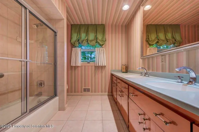 a view of a yard with plants and a large tree