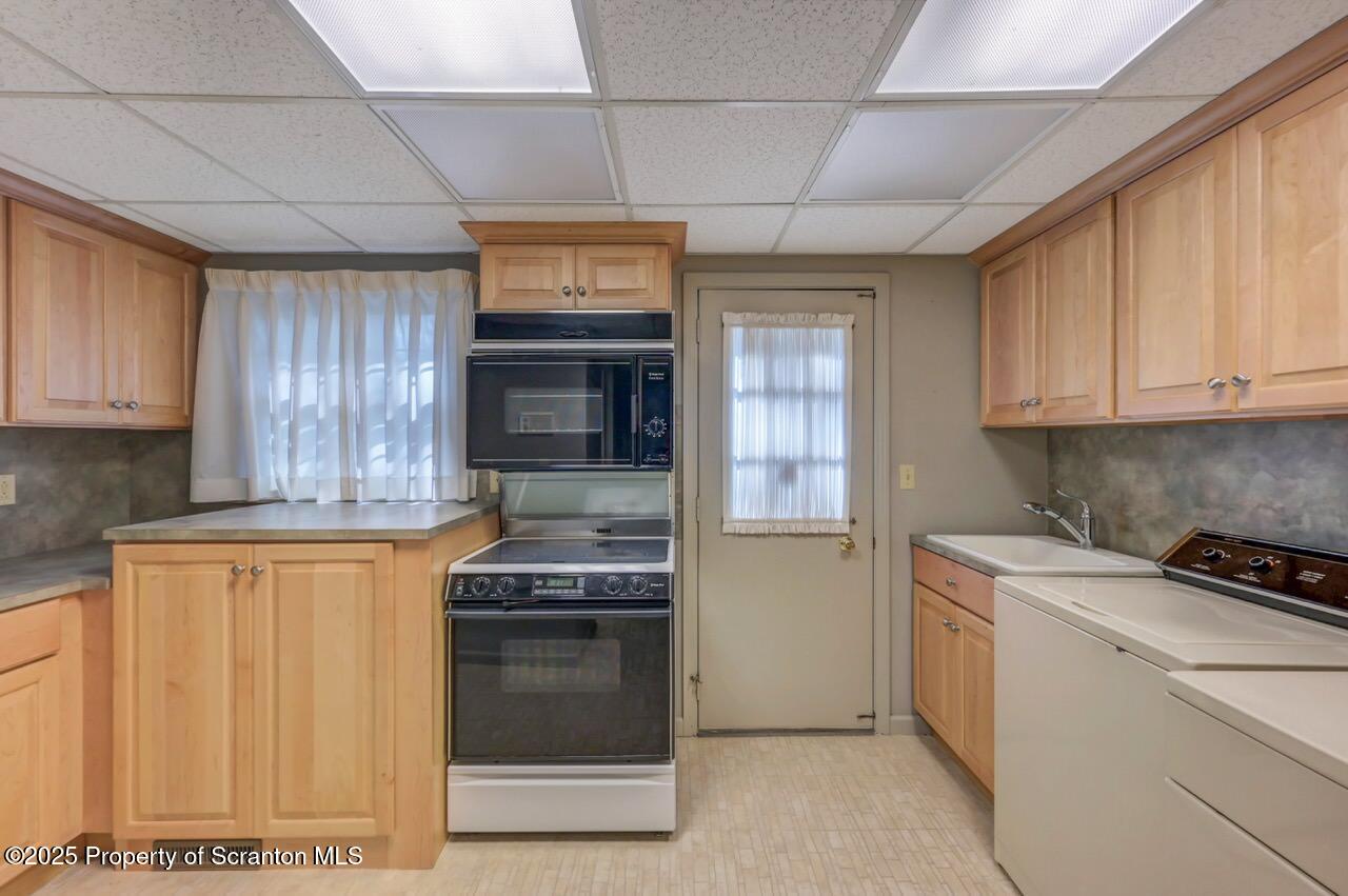 517 Grandview Street Clarks Summit, PA 18411 - Photo 59 of 86 a kitchen with stainless steel appliances granite countertop a stove a sink and a microwave