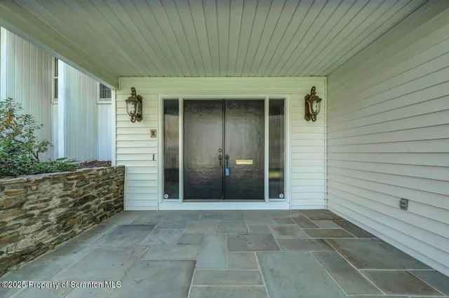 a view of an empty room with a fireplace and a window