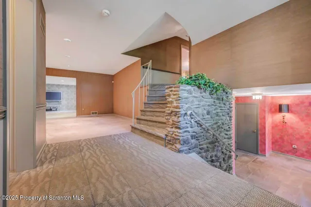 a large kitchen with stainless steel appliances kitchen island granite countertop a refrigerator a stove a microwave and a dining table