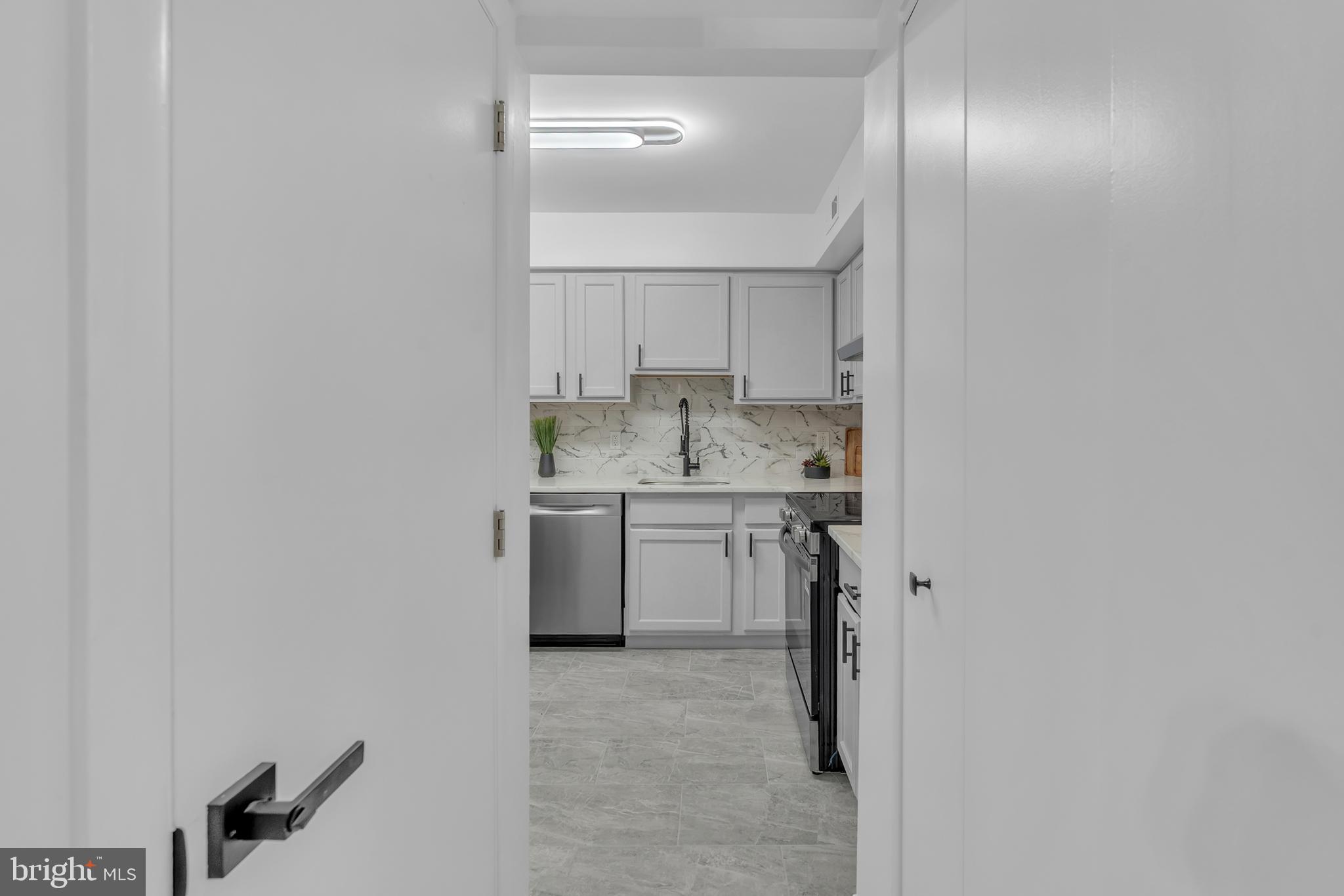 201 Timber Creek Road Clementon, NJ 08021 - Photo 21 of 62 a view of a kitchen with white cabinets and wooden floor