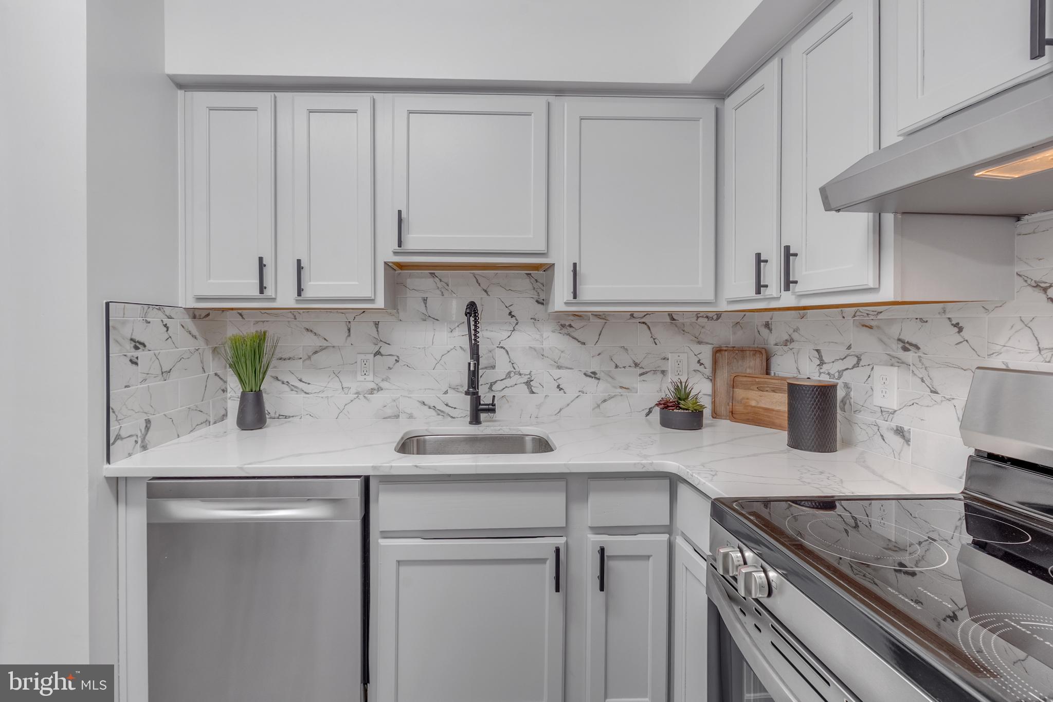 201 Timber Creek Road Clementon, NJ 08021 - Photo 25 of 62 a kitchen with stainless steel appliances granite countertop a sink a stove and white cabinets