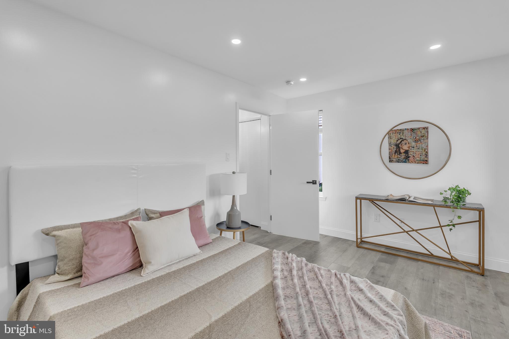 201 Timber Creek Road Clementon, NJ 08021 - Photo 29 of 62 a spacious bedroom with a bed a couch and a lamp on table