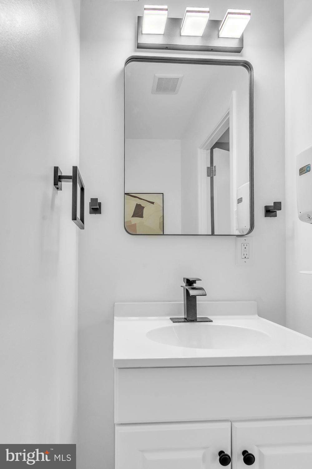 201 Timber Creek Road Clementon, NJ 08021 - Photo 52 of 62 a bathroom with a sink a mirror and vanity