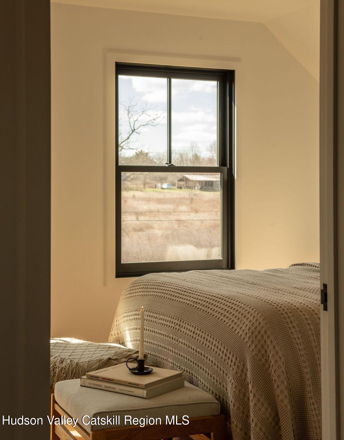 251 Viewmont Road Germantown, NY 12526 - Photo 18 of 22 a bed sitting in a bedroom next to a window