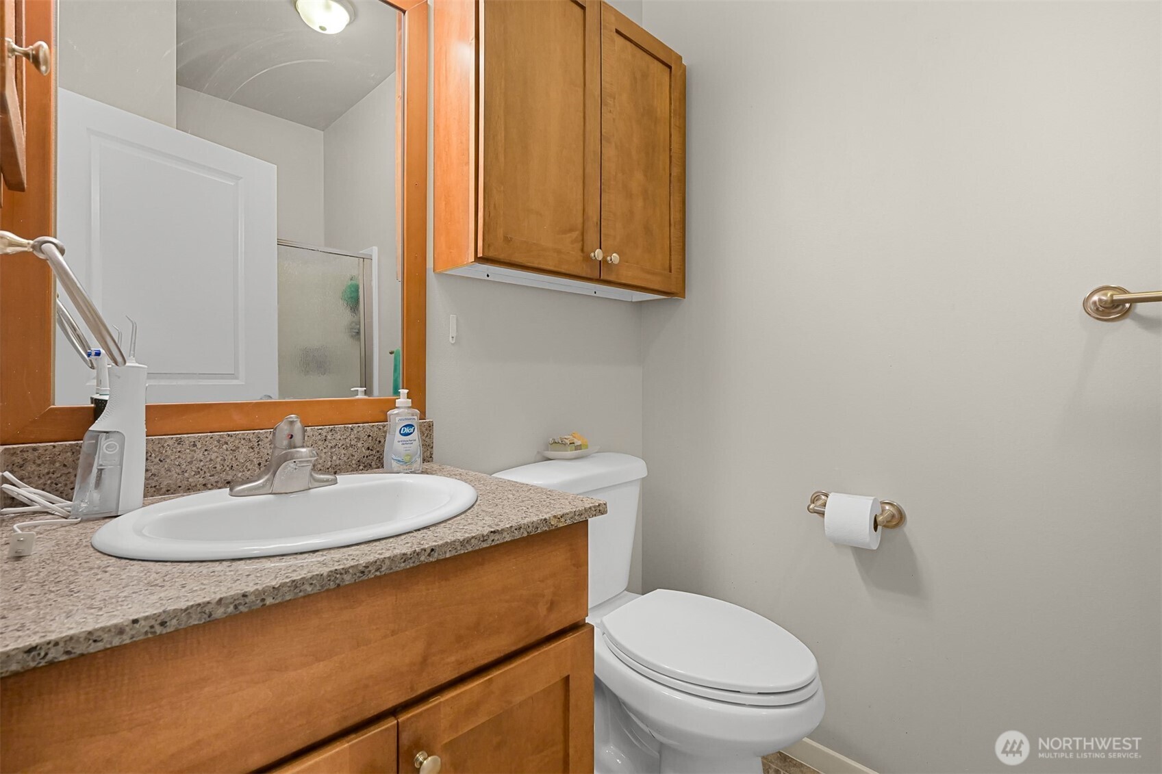 8844 Depot Road, Unit B101 Lynden, WA 98264 - Photo 12 of 30 a bathroom with a granite countertop toilet sink and mirror