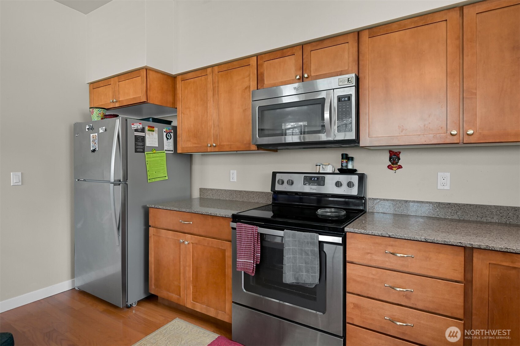 8844 Depot Road, Unit B101 Lynden, WA 98264 - Photo 5 of 30 a kitchen with stainless steel appliances granite countertop a stove a microwave and cabinets