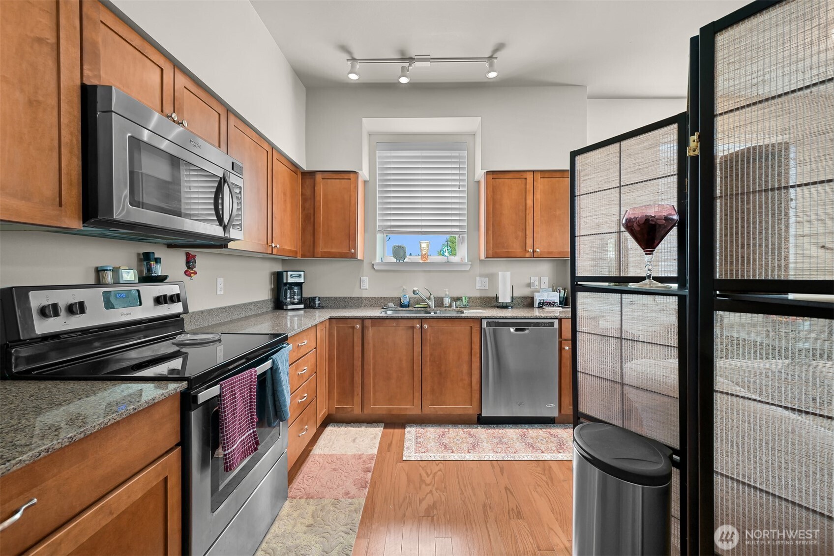 8844 Depot Road, Unit B101 Lynden, WA 98264 - Photo 8 of 30 a kitchen with granite countertop stainless steel appliances and wooden cabinets
