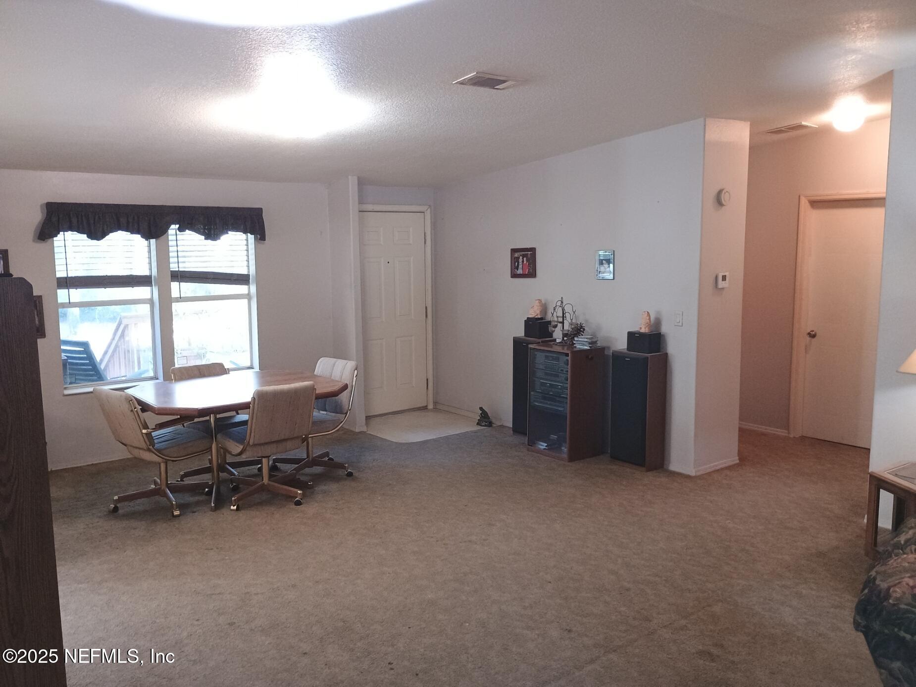 136 Boots Road Melrose, FL 32666 - Photo 11 of 40 a view of a livingroom with workspace and a window