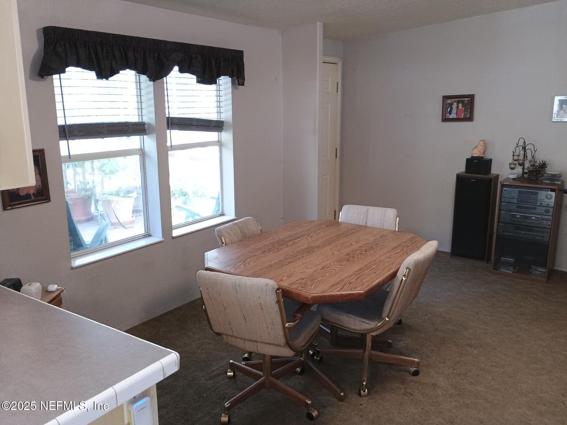 136 Boots Road Melrose, FL 32666 - Photo 13 of 40 a dining room with furniture and window