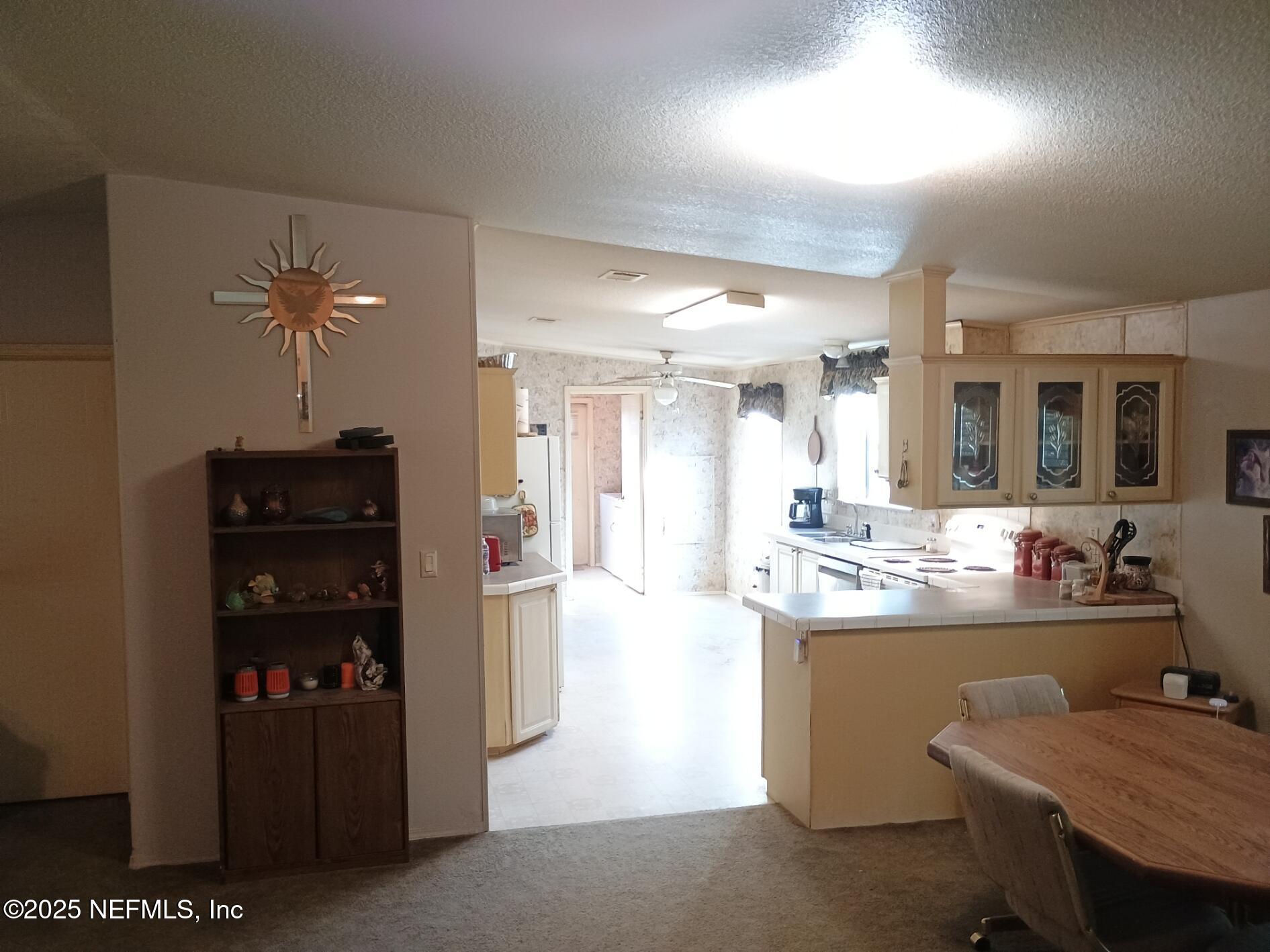 136 Boots Road Melrose, FL 32666 - Photo 14 of 40 a kitchen with refrigerator and cabinets