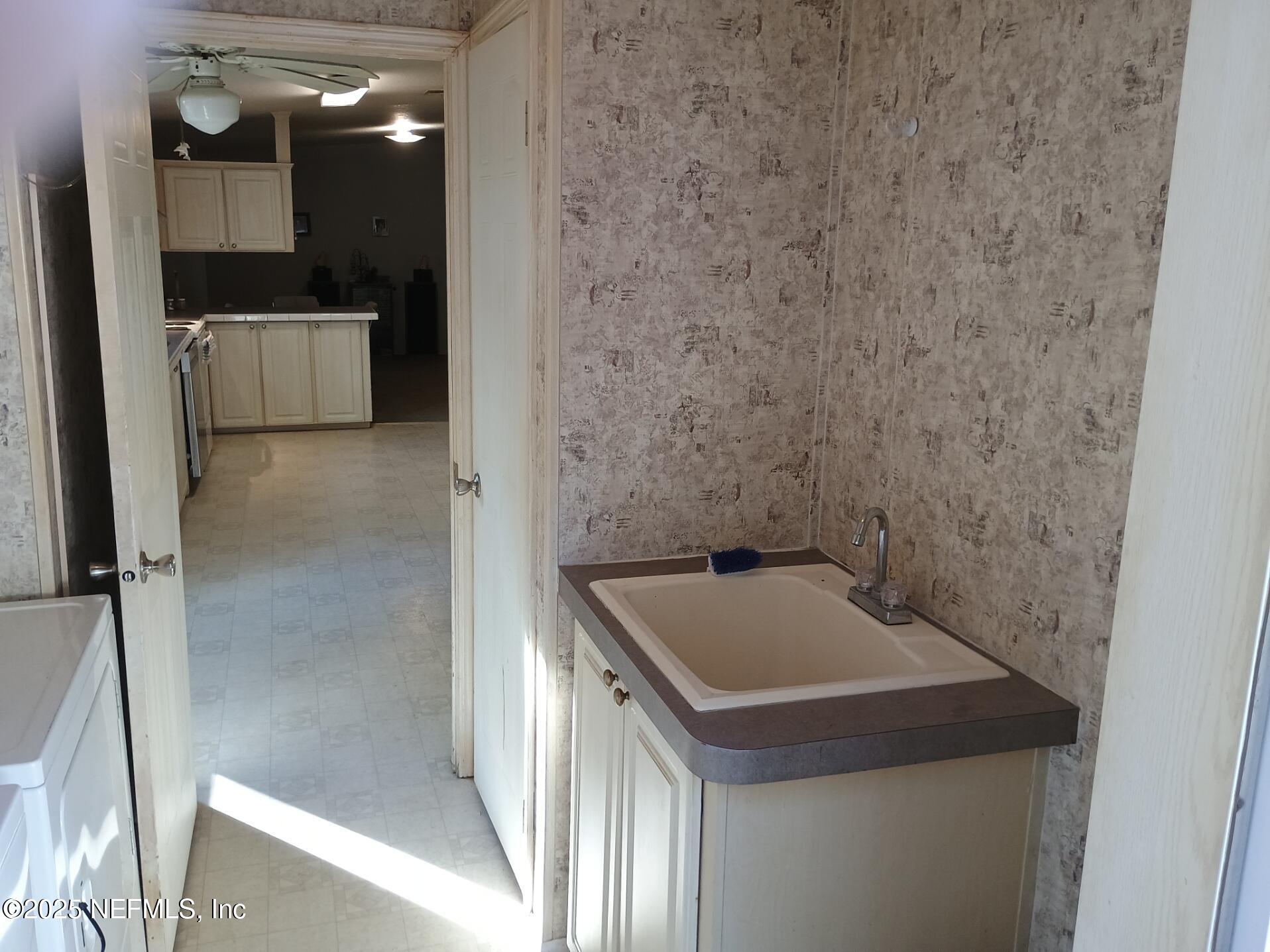 136 Boots Road Melrose, FL 32666 - Photo 21 of 40 a bathroom with a sink and a mirror