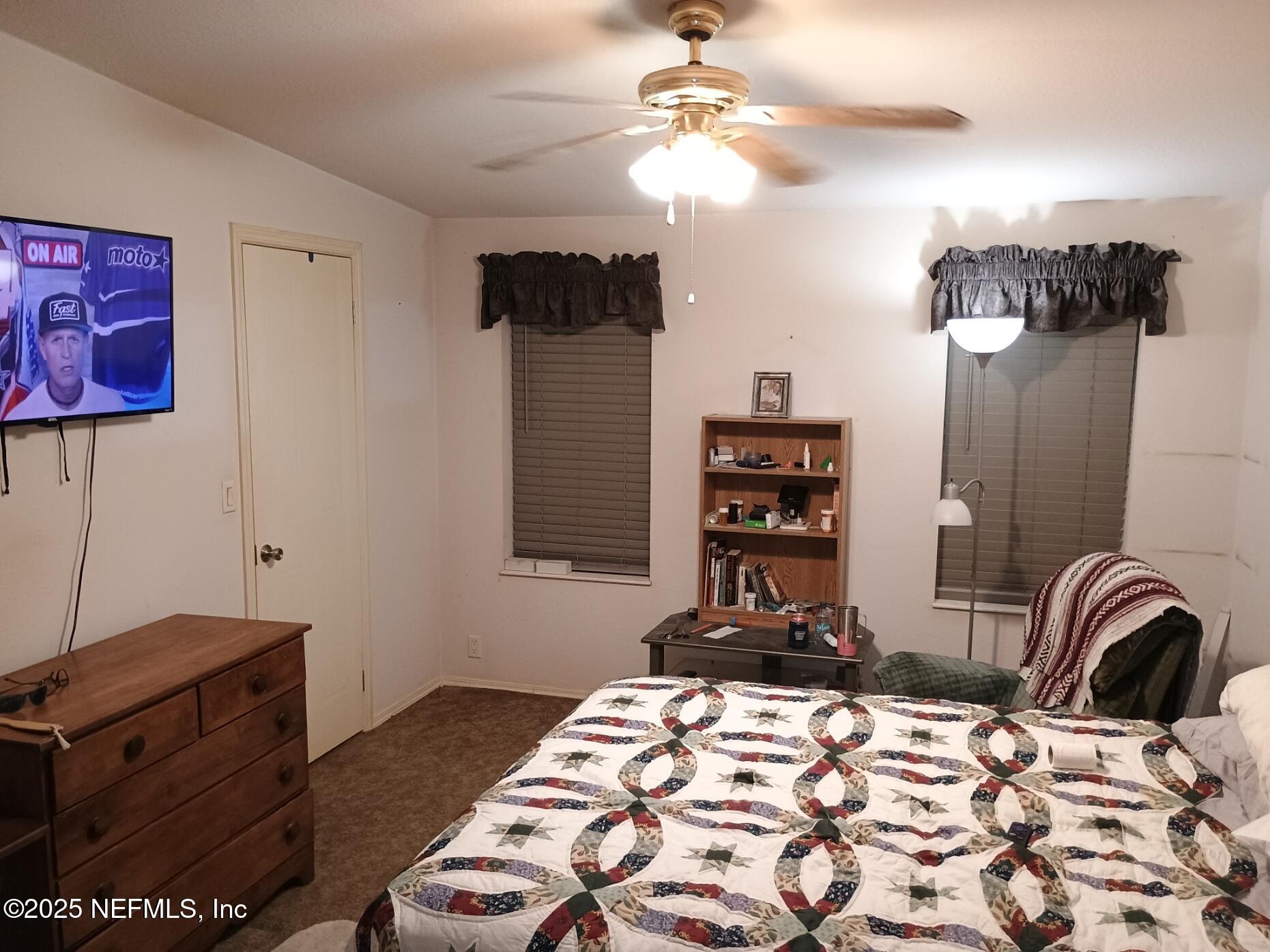 136 Boots Road Melrose, FL 32666 - Photo 28 of 40 a bedroom with a bed and wooden floor