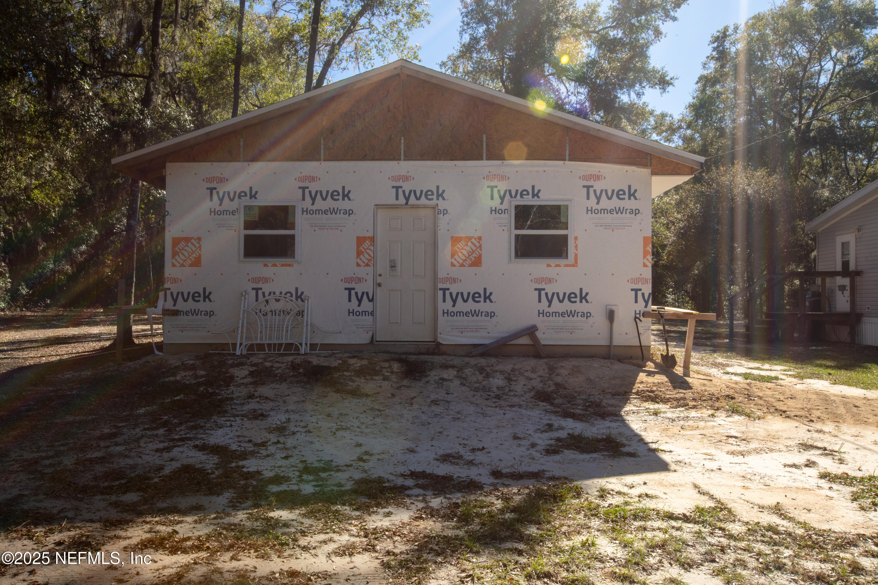 136 Boots Road Melrose, FL 32666 - Photo 30 of 40 a view of a white house with a yard covered with snow