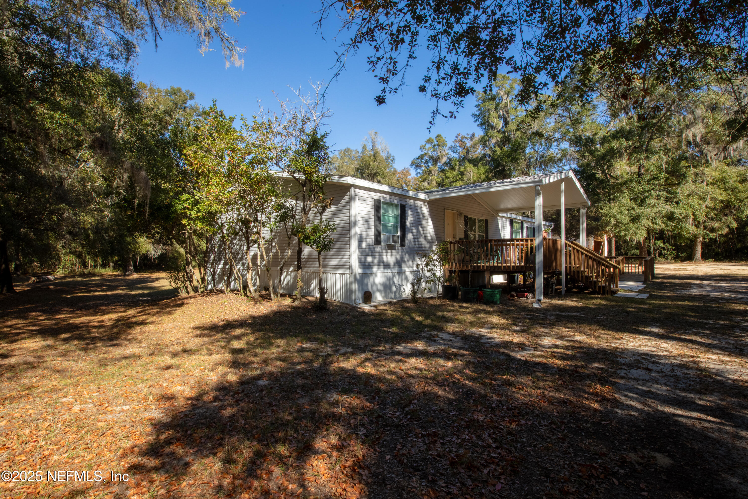 136 Boots Road Melrose, FL 32666 - Photo 4 of 40 a front view of a house with a yard