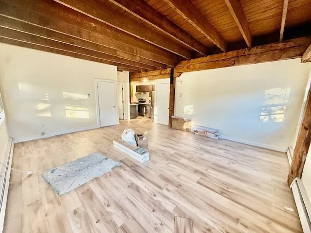 a view of a room with wooden floor