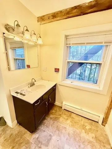 a bathroom with a sink vanity and a mirror