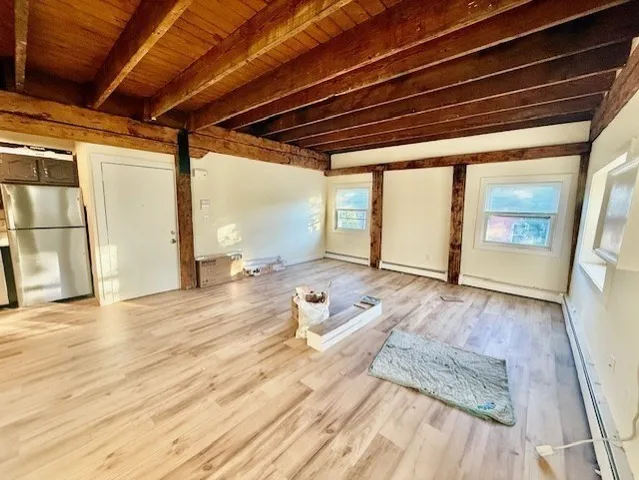 a room with wooden floor and iron stairs