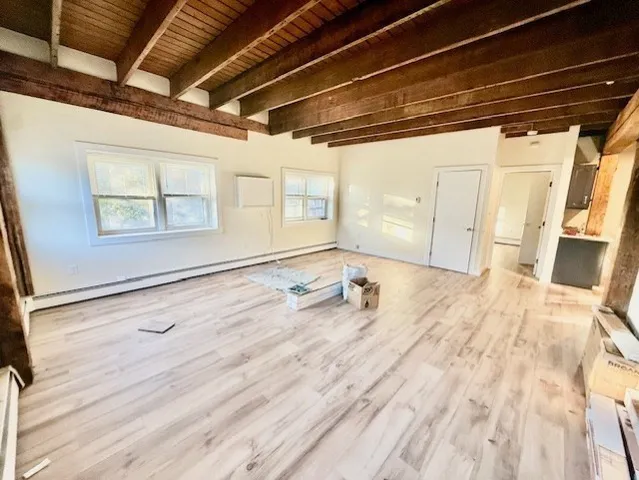 a view of a room with a wooden floor