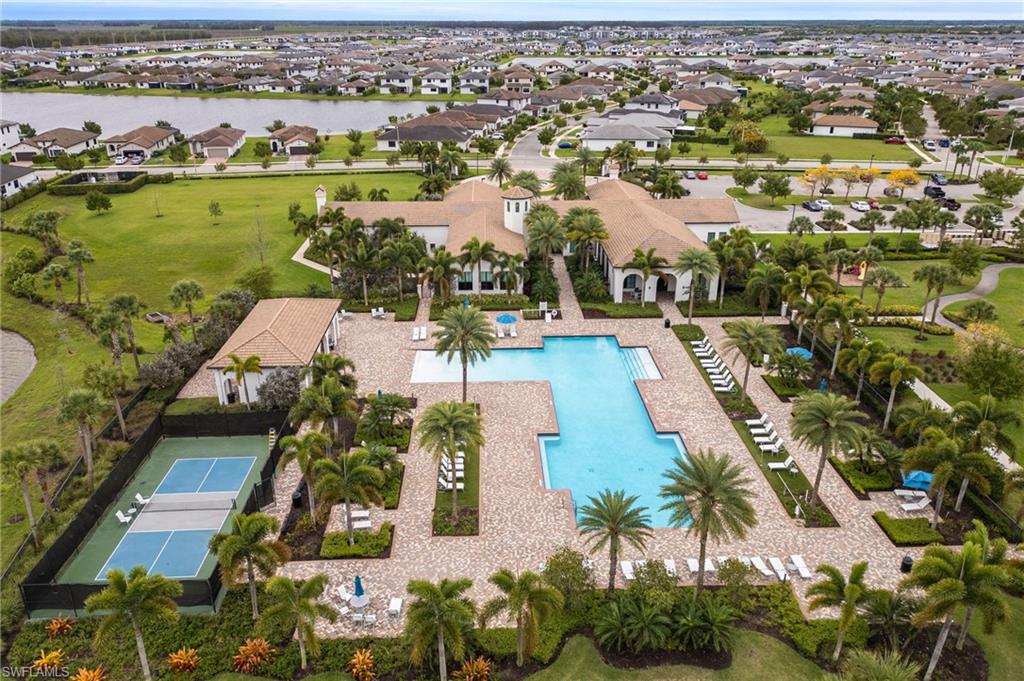 5116 Salerno Street Ave Maria, FL 34142 - Photo 34 of 36 Aerial perspective of suburban area with a nearby body of water and a pool area