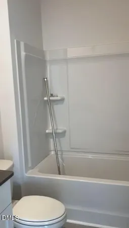 a bathroom with a toilet and a bathtub