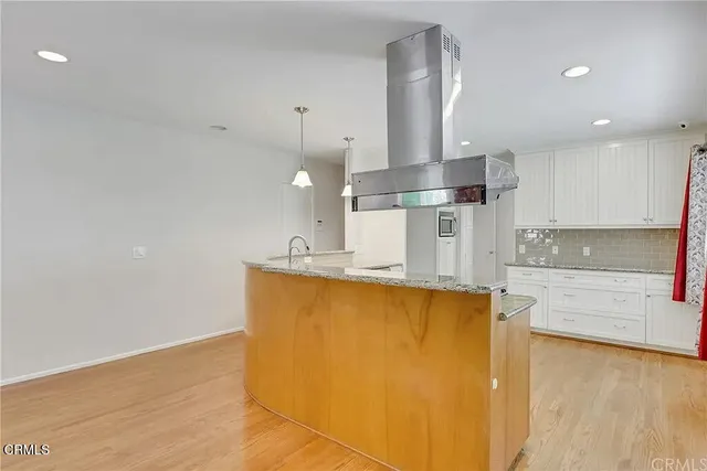 a kitchen with stainless steel appliances granite countertop a sink a stove and a refrigerator