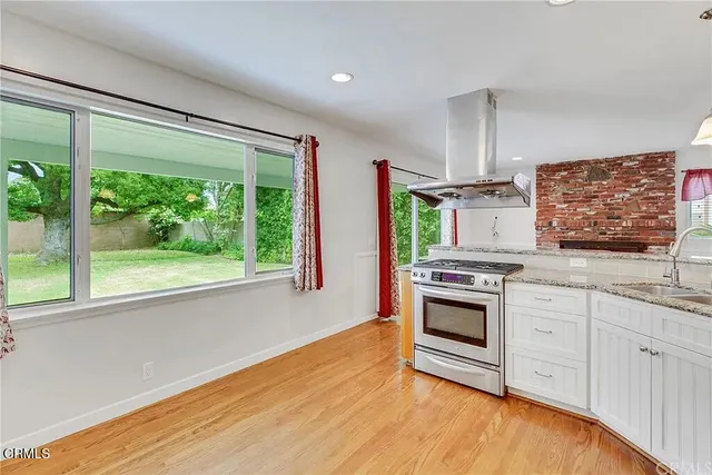 a kitchen with stainless steel appliances a stove sink and cabinets