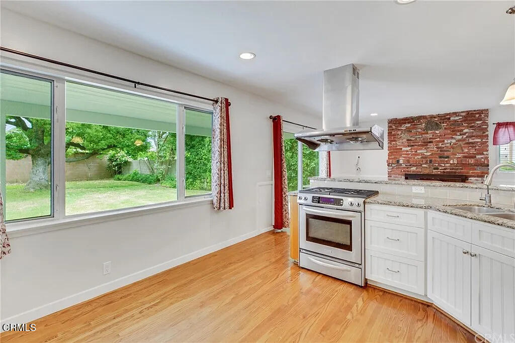 303 East Las Flores Avenue Arcadia, CA 91006 - Photo 19 of 37 a kitchen with stainless steel appliances a stove sink and cabinets