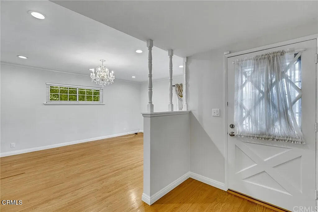 303 East Las Flores Avenue Arcadia, CA 91006 - Photo 3 of 37 a view of an empty room with wooden floor and a window