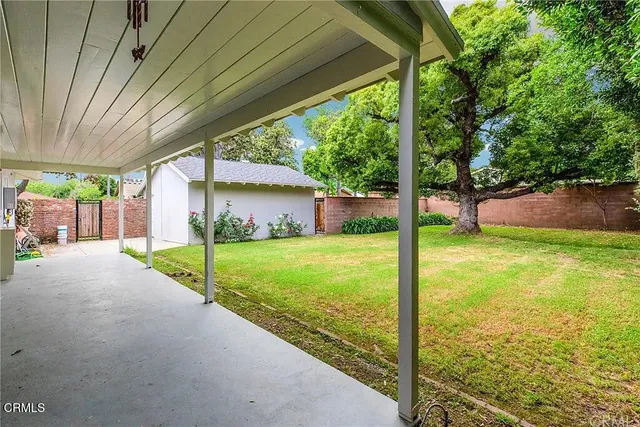 a view of a house with backyard and a patio
