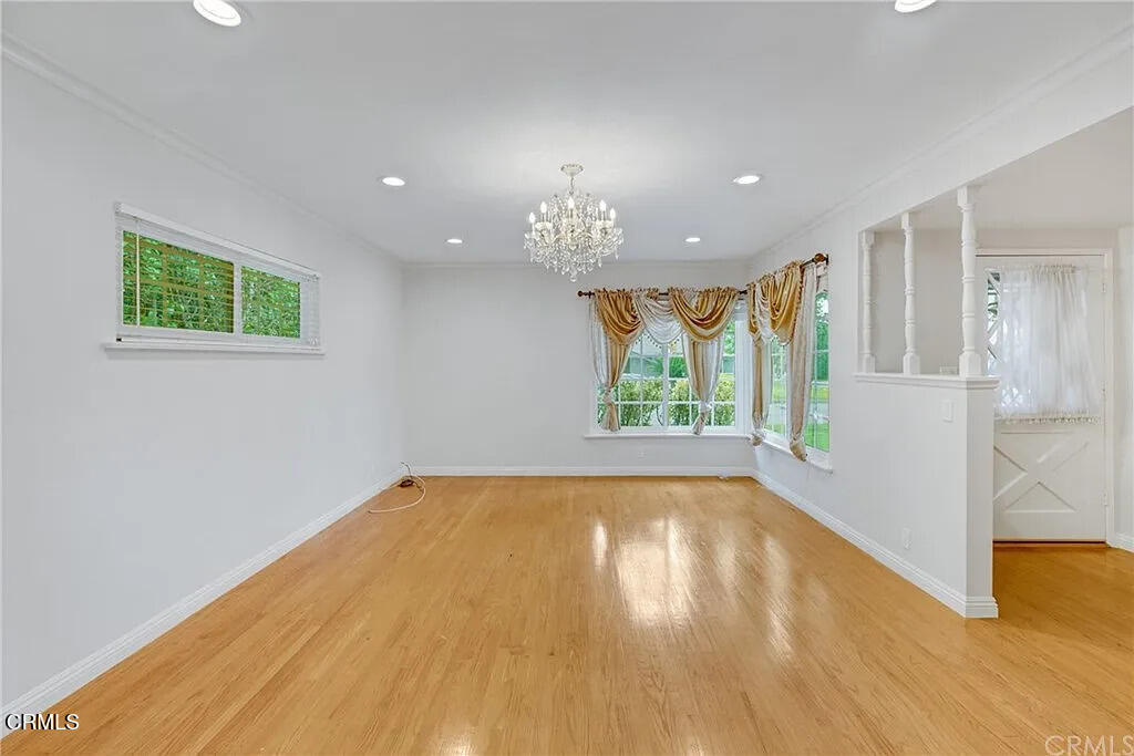 303 East Las Flores Avenue Arcadia, CA 91006 - Photo 5 of 37 a view of an empty room with wooden floor and a window