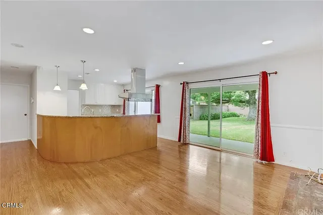 a view of kitchen with kitchen island refrigerator sink and wooden floor