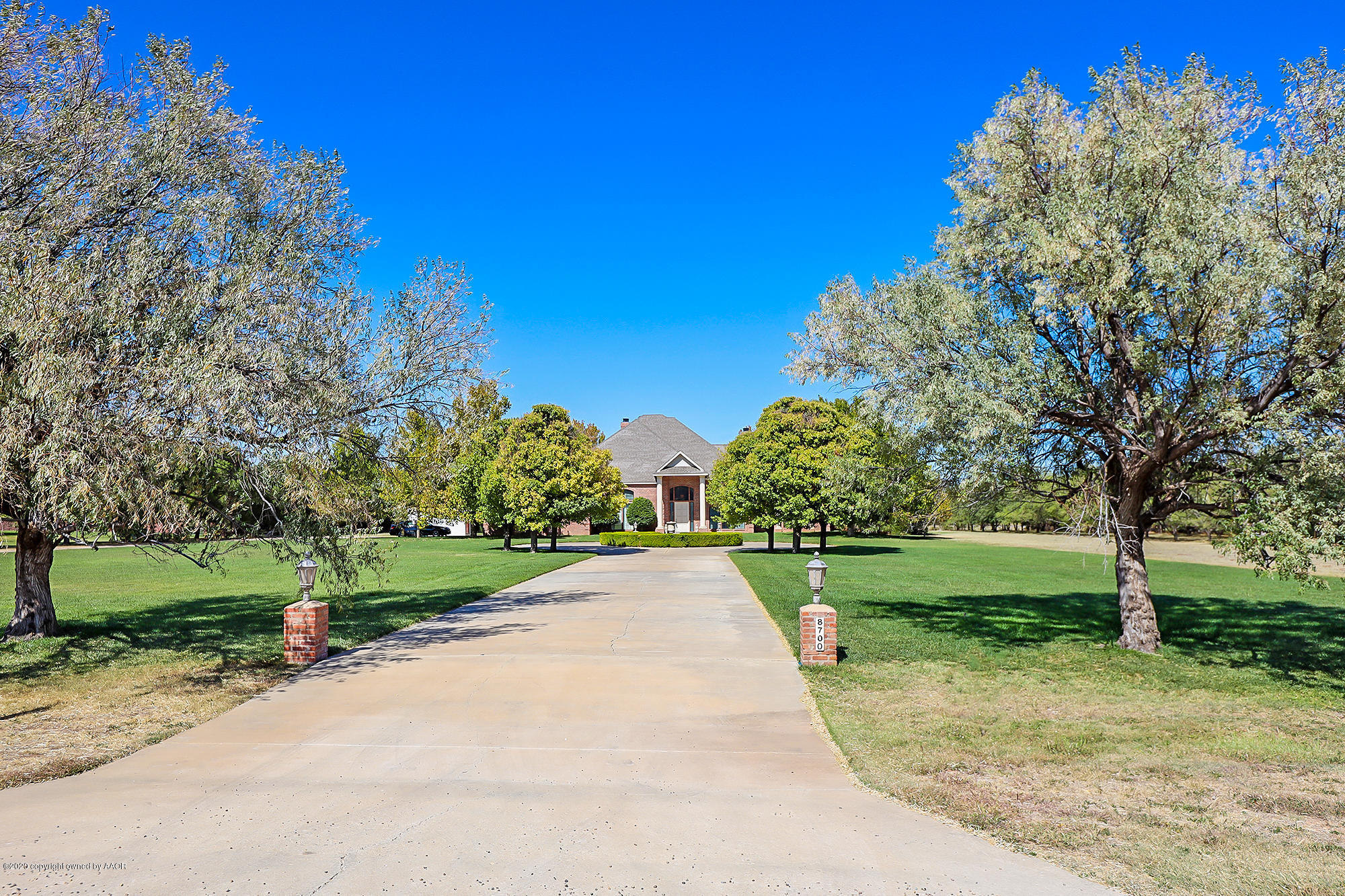 8700 Blackhawk Road Amarillo, TX 79119 - Photo 1 of 3 a view of a park with large trees and a small yard