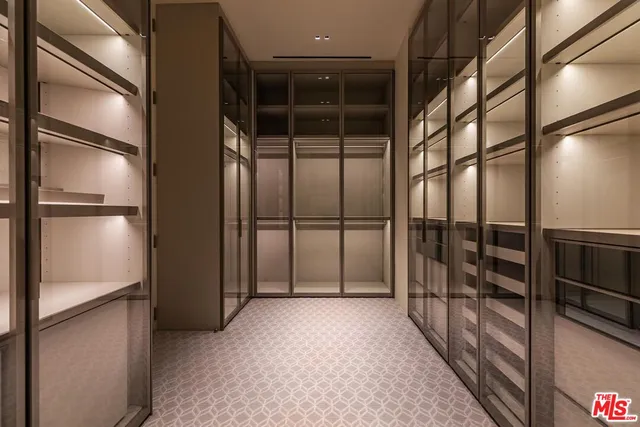 a bathroom with a white tub a sink a mirror and a shower