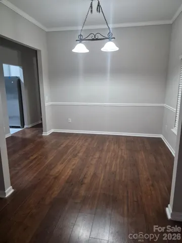 a view of a room with wooden floor