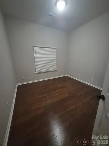 an empty room with wooden floor