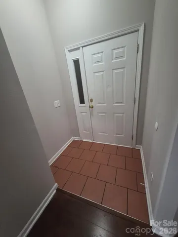 an empty room with wooden floor