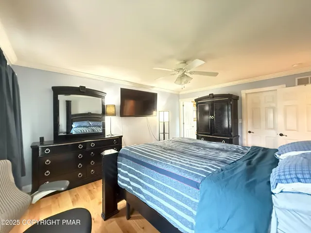 a bedroom with a bed and a flat screen television