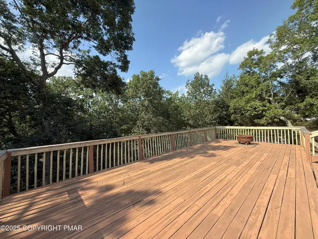 a view of balcony with wooden floor and fence