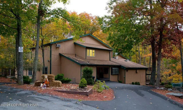 a front view of a building with a parked car