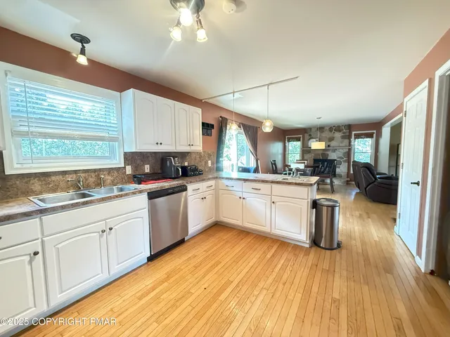 a kitchen with a sink window and cabinets