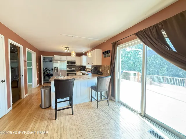 a open kitchen with dining table and chairs